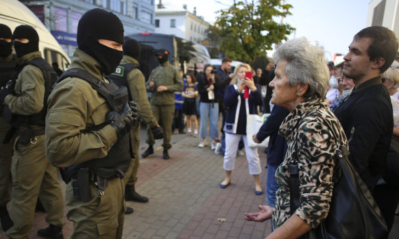 A woman argues with a police officer during an opposition rally to protest the official presidential election results in Minsk, Belarus.