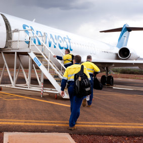 Rio Tinto Group workers from the West Angelas iron ore mine at an airstrip in the Pilbara, WA.