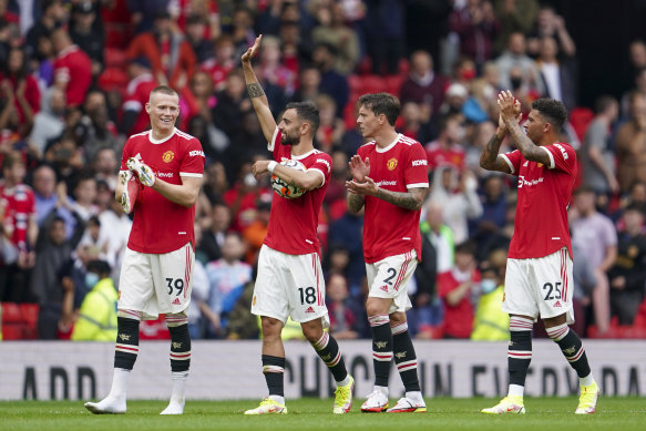 Manchester United players wave to the crowd following the English Premier League soccer match between Manchester United and Leeds United at Old Trafford on August 14.