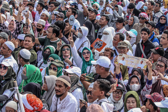 Supporters of Indonesian presidential candidate Anies Baswedan gather during a campaign event.
