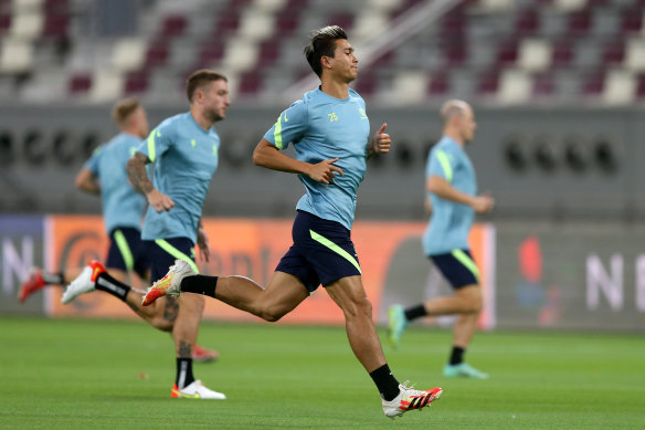 Australia players attend a training session ahead of the FIFA 2022 World Cup Qualifier in Khalifa International Stadium. The pitchside air vents can be seen in the background.