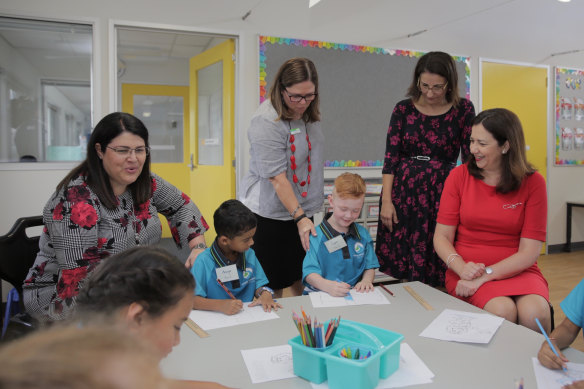 Then-premier Annastacia Palaszczuk, picture in 2019 at Spring Mountain State School near Springfield, pledged to hire 6190 teachers and 1139 aides if her government won the 2020 election.