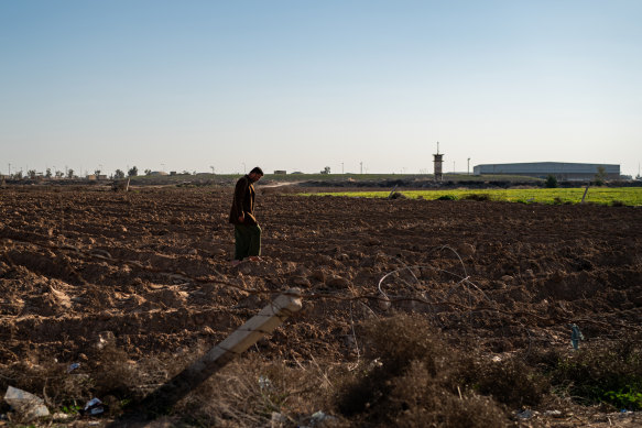 Tamim Ahmed al-Tamimi, 35, walks in his farm field next to Joint Base Balad near the town of Balad, Iraq, on February 23.