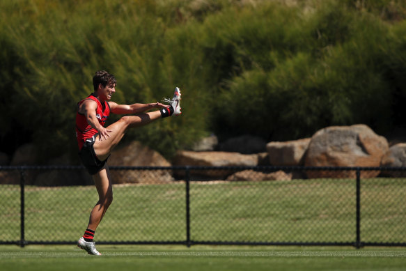 Former Giants midfielder Jye Caldwell lets fly during an Essendon training session.