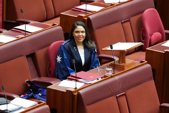 Senator Jacinta Nampijinpa Price wears the Australian flag in the Senate on Wednesday.