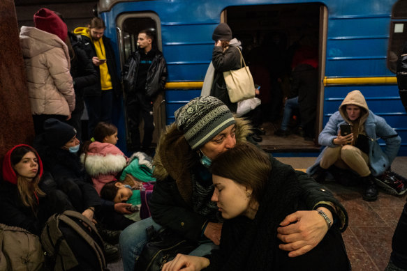 Hundreds of people take shelter inside a downtown Kharkiv metro station as explosions are heard outside on February 24. 