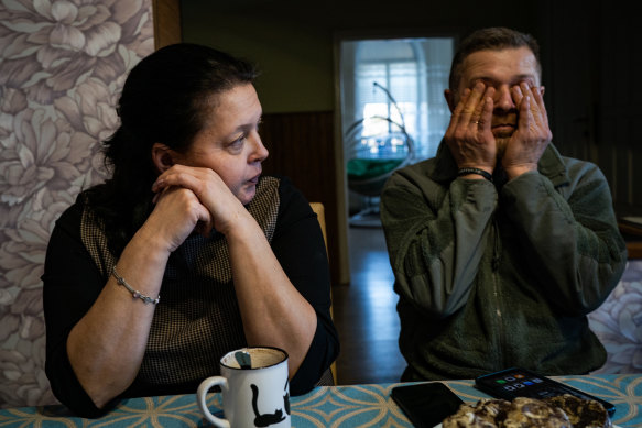 Svetlana Pechenii and her husband, Yuri Pechenii, chat at the kitchen table on February 21 after helping their foster children pack their belongings in case they need to evacuate amid fears of a possible full-scale invasion by Russia.