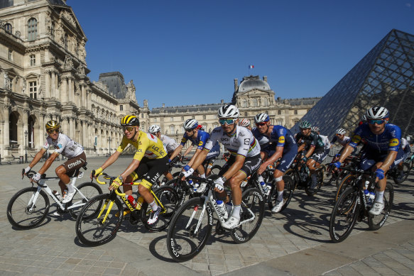 Yellow jersey Tadej Pogacar leads the peloton past the Louvre on Sunday.