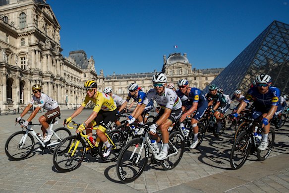 Yellow jersey Tadej Pogacar leads the peloton past the Louvre on Sunday.