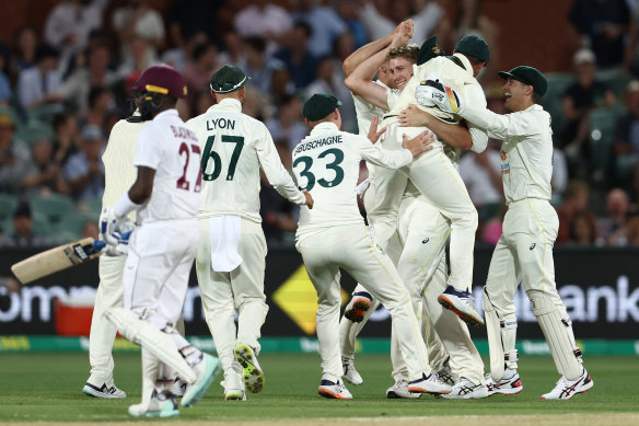 Cameron Green and Scott Boland celebrate the wicket of Jermaine Blackwood with teammates on Saturday night.