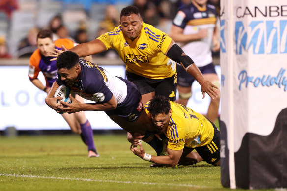 Irae Simone scores a try against the Hurricanes.