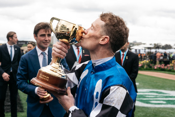Mark Zahra kisses the Melbourne Cup after winning aboard Gold Trip.