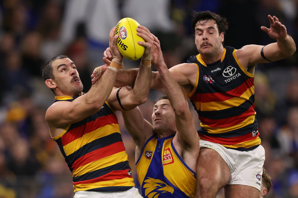 Taylor Walker and younger teammate Darcy Fogarty fly for a mark against West Coast’s Jeremy McGovern.