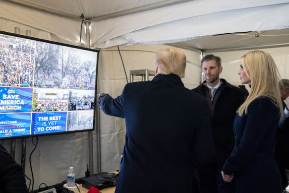 Then-president Donald Trump watches video monitors showing the crowd gathered on the Ellipse on the morning of the riots, before he spoke. At right are his son Eric and daughter Ivanka.