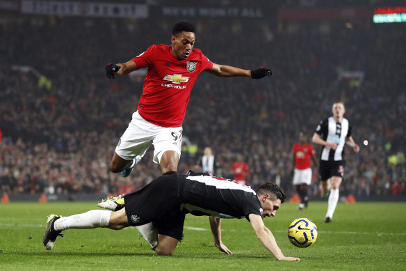 Manchester United's Anthony Martial battles for the ball with Newcastle's Fabian Schar.
