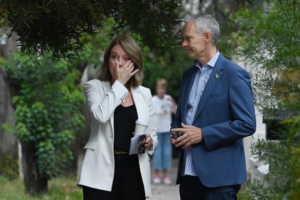 A visibly upset Kellie Sloane, member for Vaucluse, talks with President of Emanuel Synagogue Grant McCorquodale.