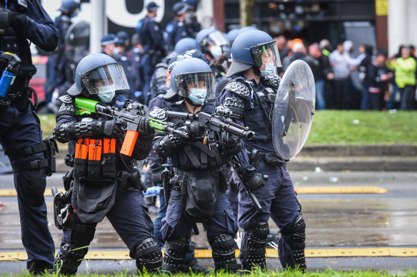 Riot police move in to control a violent protest in the Melbourne CBD in September 2021.