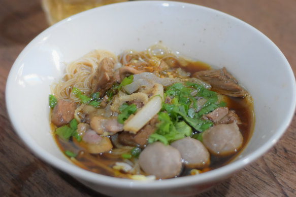 Kuy teav, the clear, pork- and dried-shrimp-based broth and its various toppings.