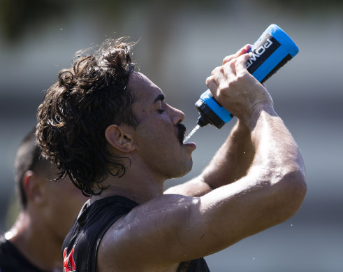Welcome home: Daine Laurie tries to stay hydrated as temperatures soared to 40 degrees out west on Thursday.