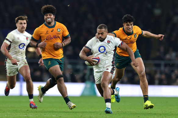 Ollie Lawrence of England gets away from Joseph-Aukuso Suaalii at Twickenham.