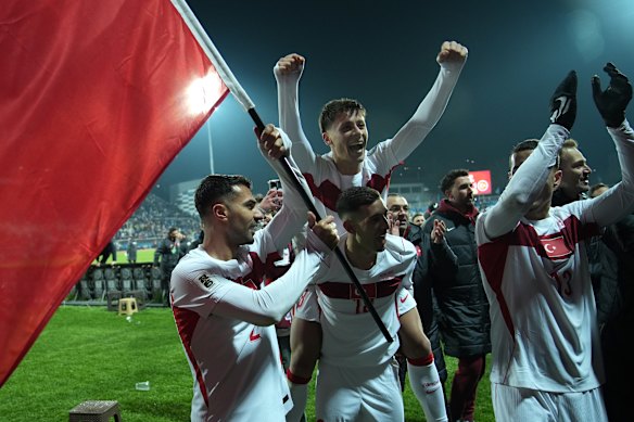 Zeki Celik, Arda Guler and Mert Muelduer celebrate Turkey’s qualification for the World Cup.