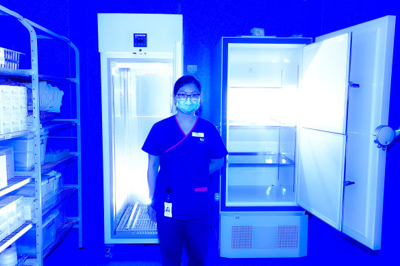 Pharmacist Lei Ching Yeoh with an ultra-low temperature freezer at the vaccination hub at Sunshine Hospital.