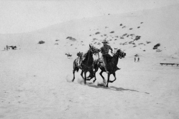 A mounted member of the 1st Australian Light Horse Regiment practises bringing in a wounded comrade laid across a horse. 