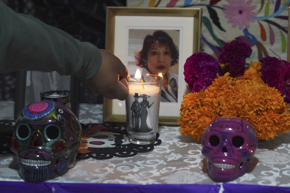 Brayan Cervantes lights a candle to remember his mother who died from COVID-19 complications in Ecatepec, Mexico.