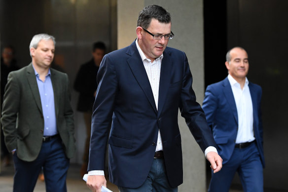 Victoria's Chief Health Officer  Brett Sutton (left), Premier Daniel Andrews and Education Minister James Merlino leave a press conference on Tuesday.