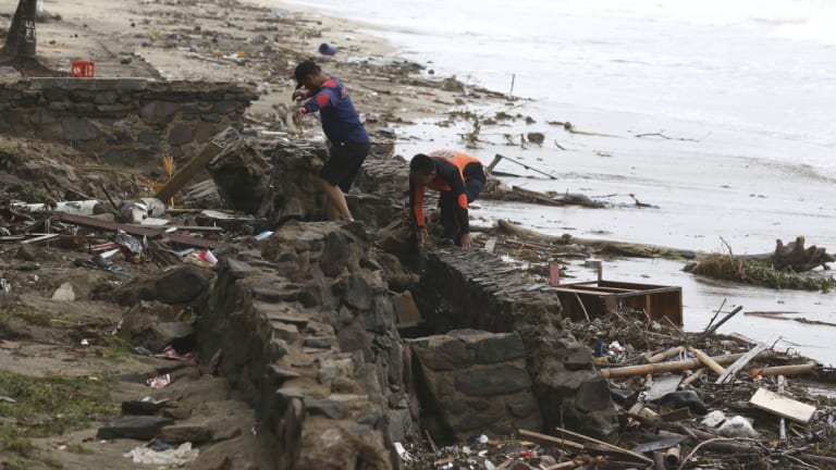 Indonesian rescuers search for the bodies of tsunami victims in Carita, Indonesia.