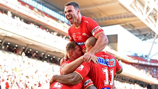 The Dolphins celebrate a try in their win over the Roosters on Sunday.