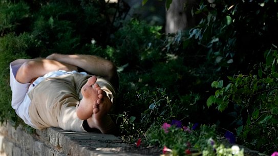A man finds shade in London. The British Met Office says temperatures won’t peak until next week.