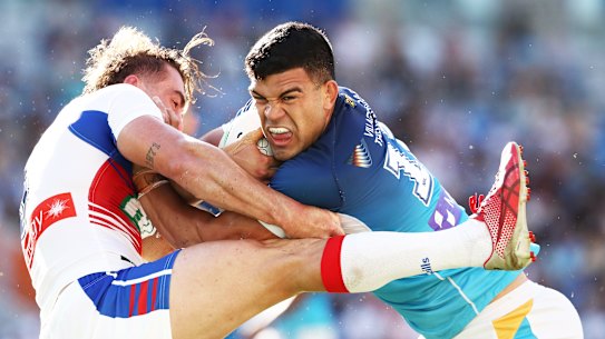 The Knights’ Connor Watson struggles to contain a rampaging David Fifita.