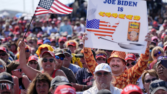 Supporters wait for Donald Trump to take the stage ahead of the chaos.
