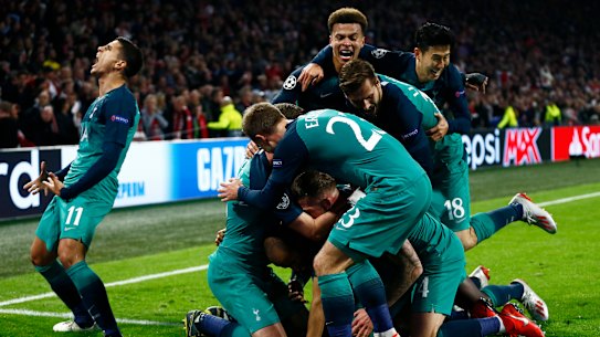 Triumphant: Tottenham players following Lucas Moura's third and decisive strike.