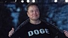 Elon Musk flashes his “DOGE” T-shirt while at the White House.