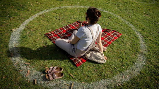 Social circles: People sit on the grass at Princes Park in Melbourne on Saturday. 
