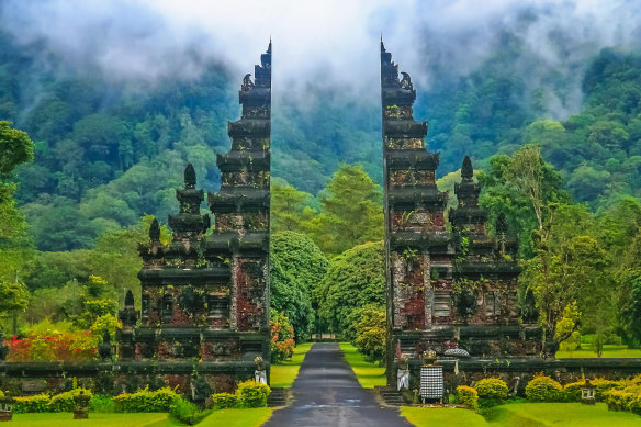 A gate to a Hindu temple, set amid jungle.
