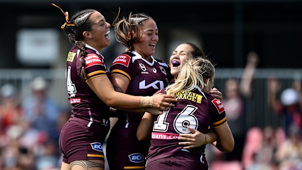 Broncos players celebrate defeating the Warriors in the final round of the regular season.
