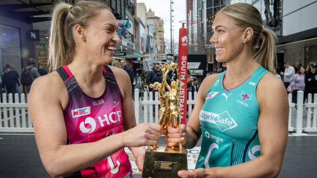 Adelaide Thunderbirds captain Hannah Petty and Melbourne Vixens counterpart Kate Moloney with the Super Netball trophy.