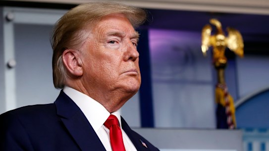 President Donald Trump listens as Agriculture Secretary Sonny Perdue speaks about the coronavirus.