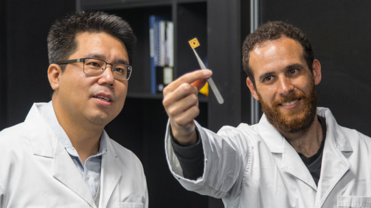 Dr Dongchen Qi (left) with QUT student David Sommers and one of the team's diamond circuits.