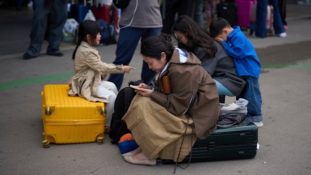 People wait outside a closed train station during a major power outage in Barcelona on Monday.