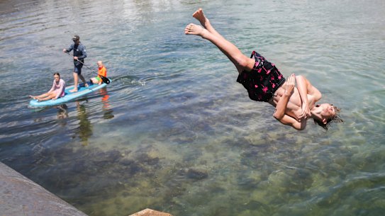 Swimmers enjoy the warm weather at Narrabeen Lakes on Sydney’s northern beaches on Sunday.
