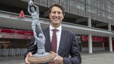 Former Queensland and Wallabies captain John Eales stands next to a model of a statue of himself at Suncorp Stadium on Monday.