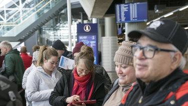 Passengers wait to board a budget airline last year. 