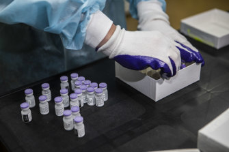 A worker at Monash Medical Centre retrieves vials of the Pfizer vaccine from the freezer on Wednesday.