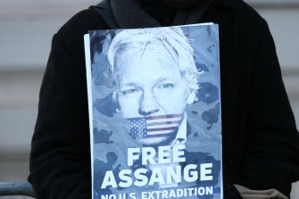 A supporter demonstrates outside Westminster Magistrates Court during an extradition hearing on November 18.