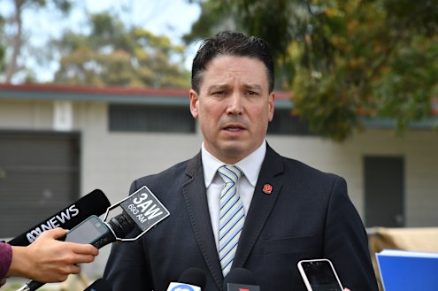 Tim Day speaks to the media outside a homicide scene in 2019.