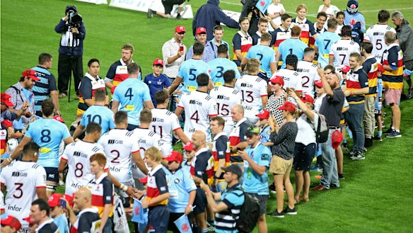 Poignant: The teams enter the field together as a mark of solidarity.